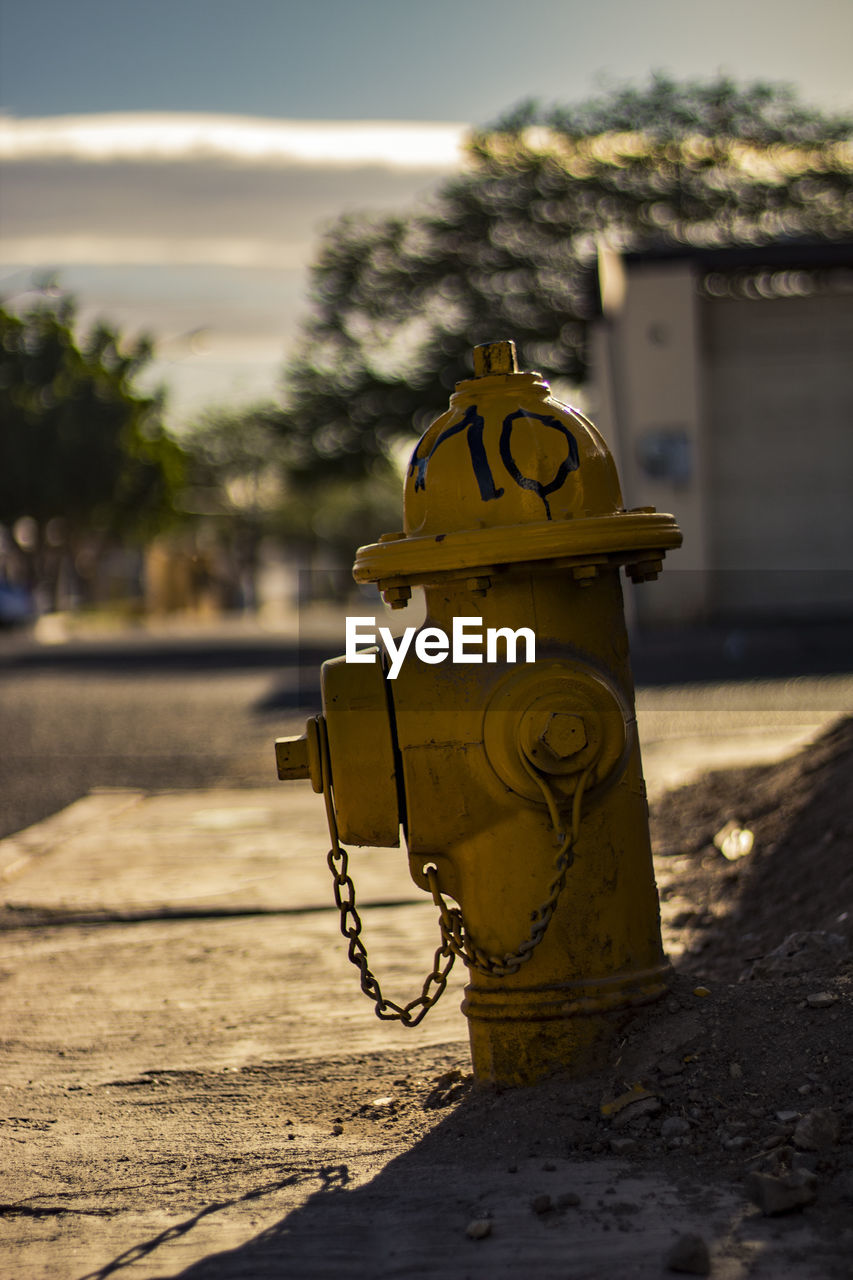 CLOSE-UP OF FIRE HYDRANT AT SUNSET