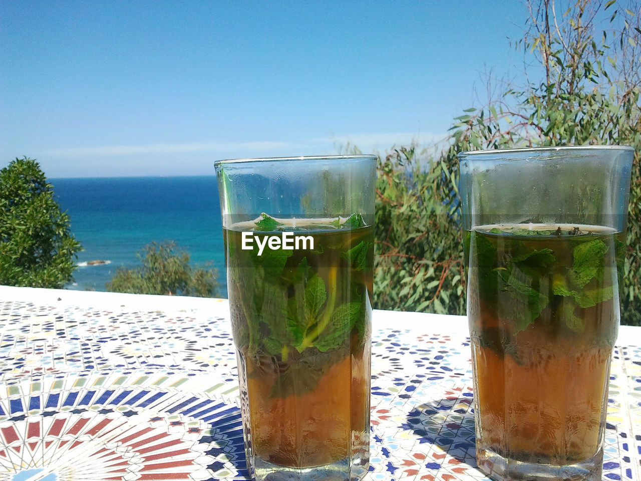 Close-up of drink in glass on table against clear sky