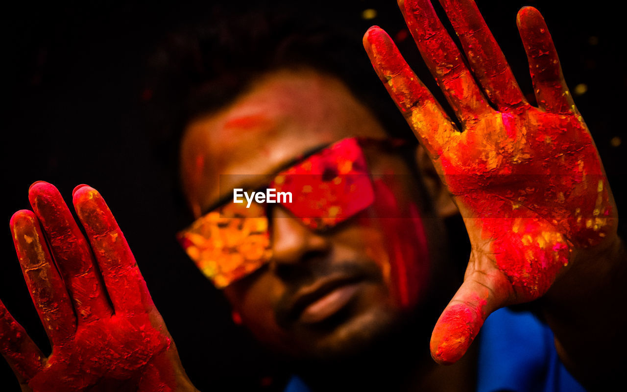 Portrait of a male happy indian celebrating holi with paint. concept of the indian festival holi.