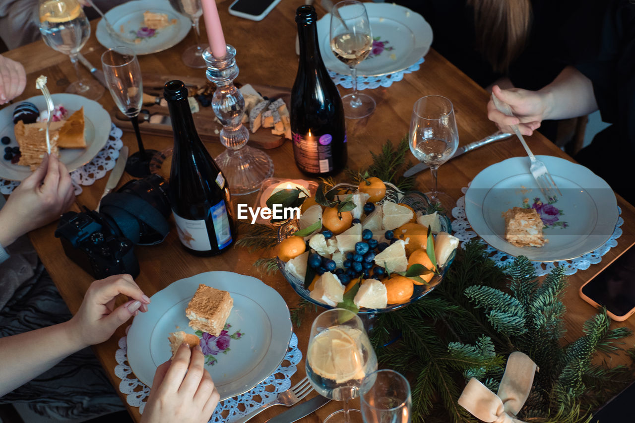 Christmas dinner with tangerines, candles and spruce branches for decoration