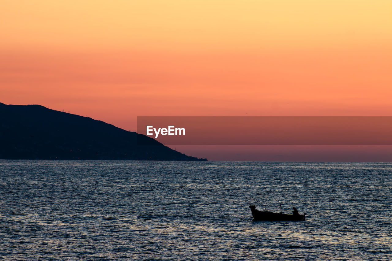 scenic view of sea against orange sky