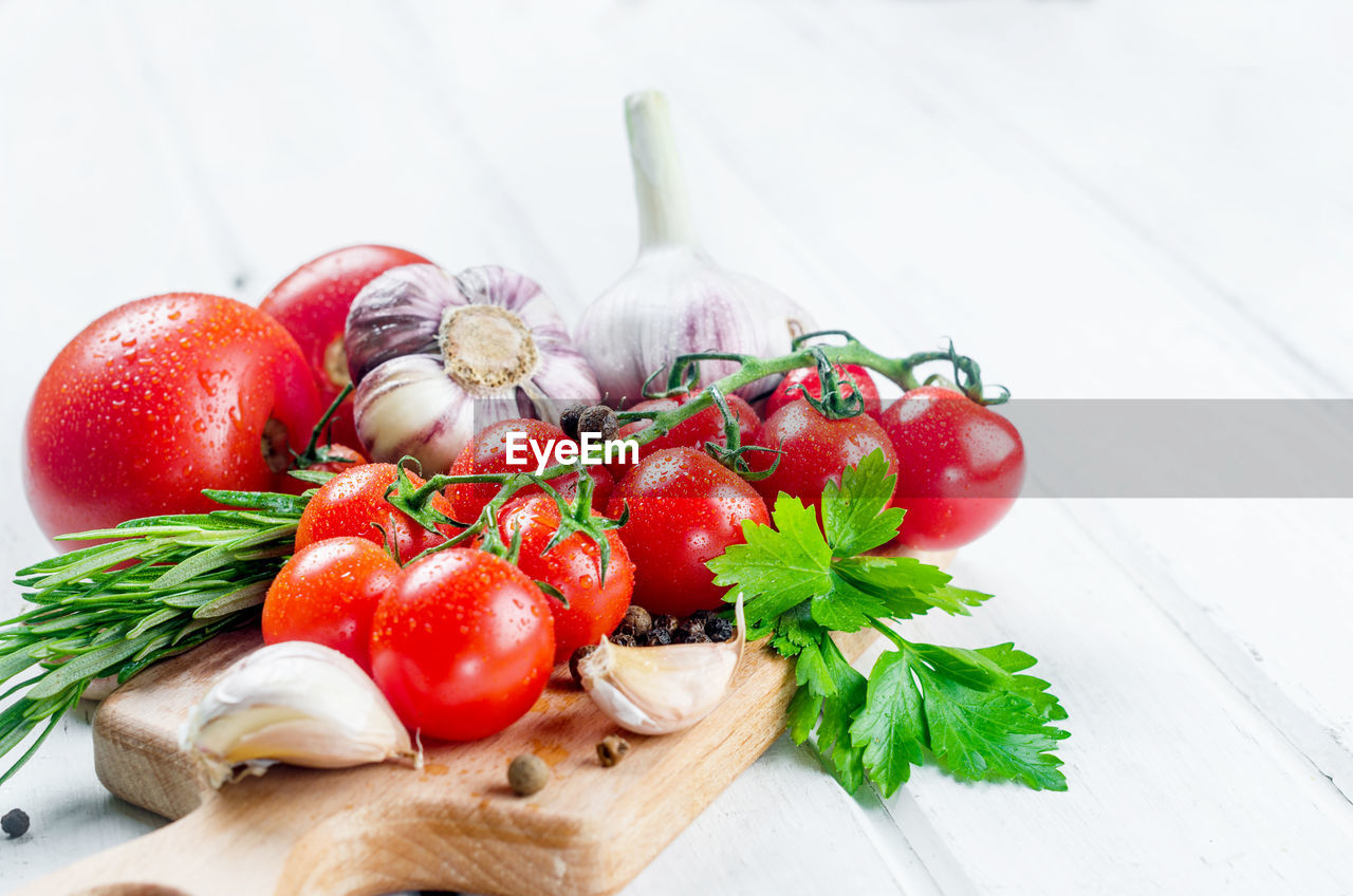 CLOSE-UP OF CHERRIES AND FRUITS ON TABLE