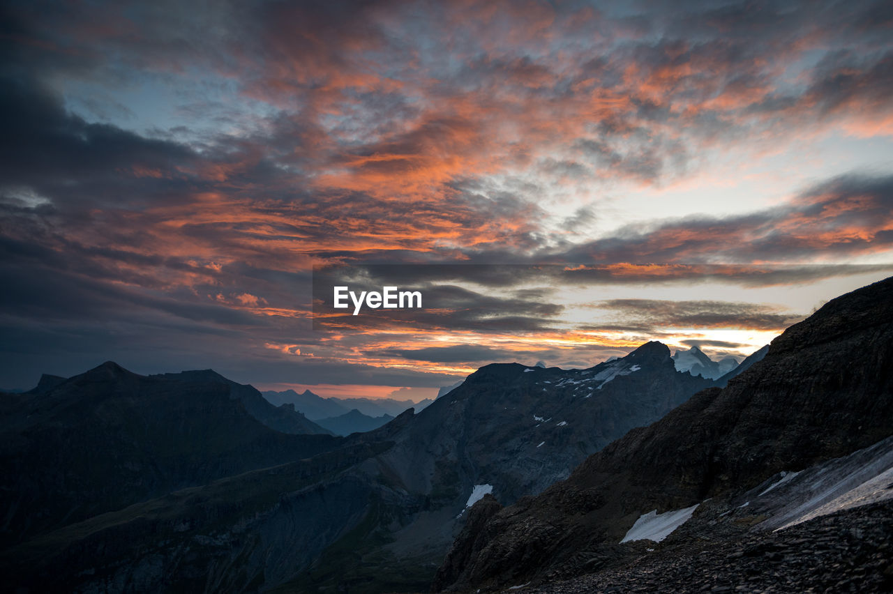 SCENIC VIEW OF SNOWCAPPED MOUNTAINS AGAINST SUNSET SKY