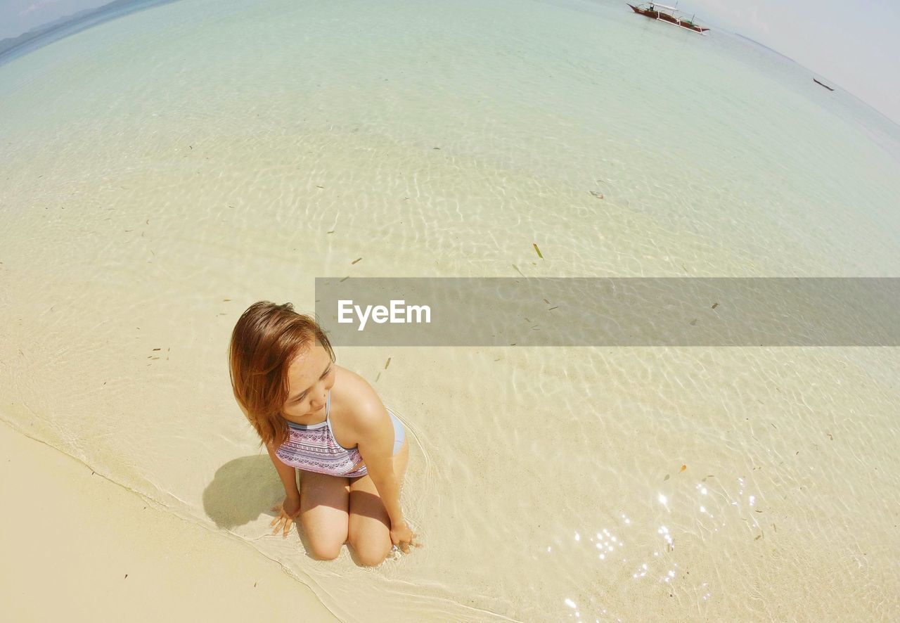HIGH ANGLE VIEW OF GIRL ON BEACH