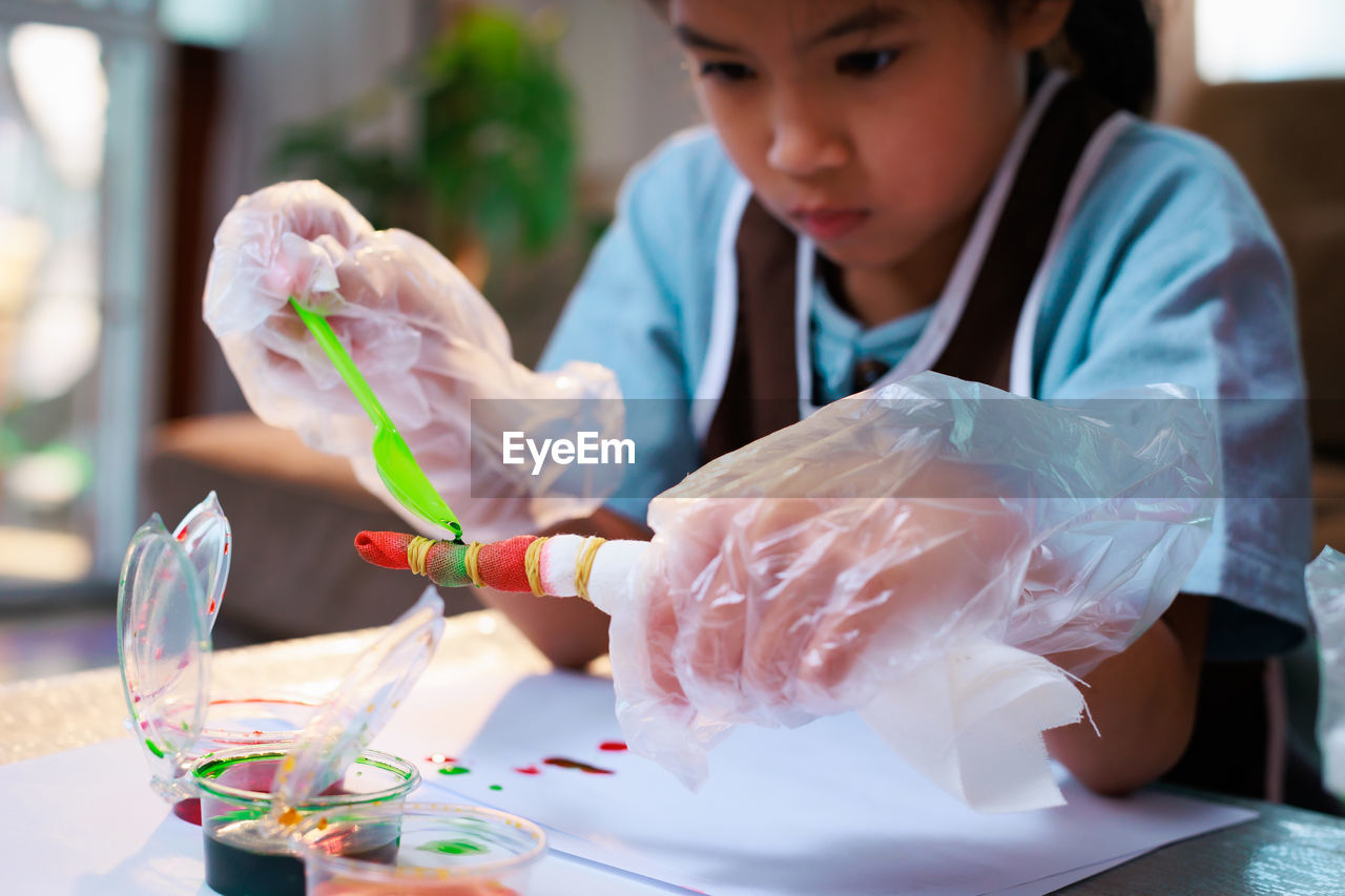 close-up of girl painting on table