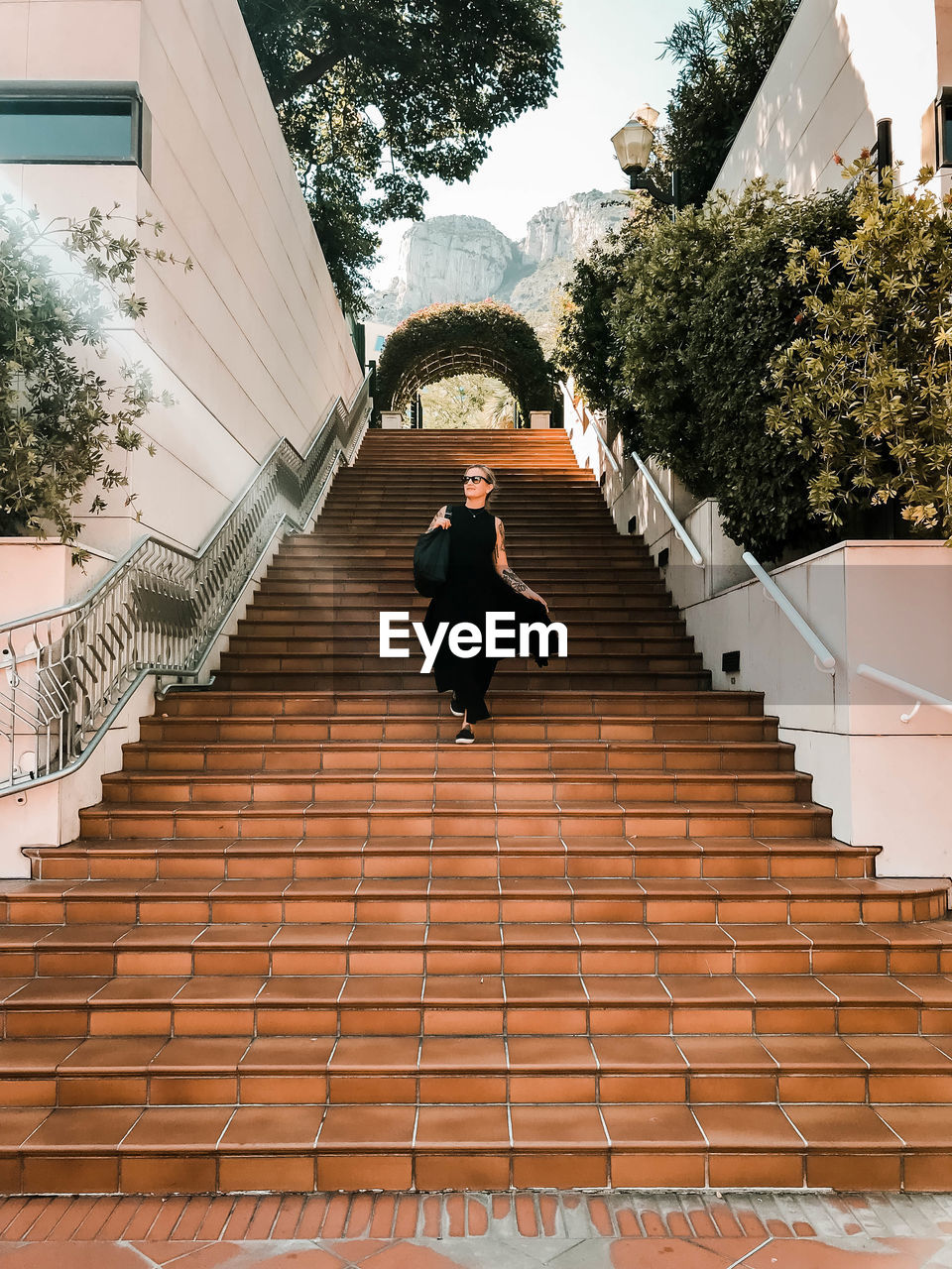 Rear view of woman walking on staircase of building