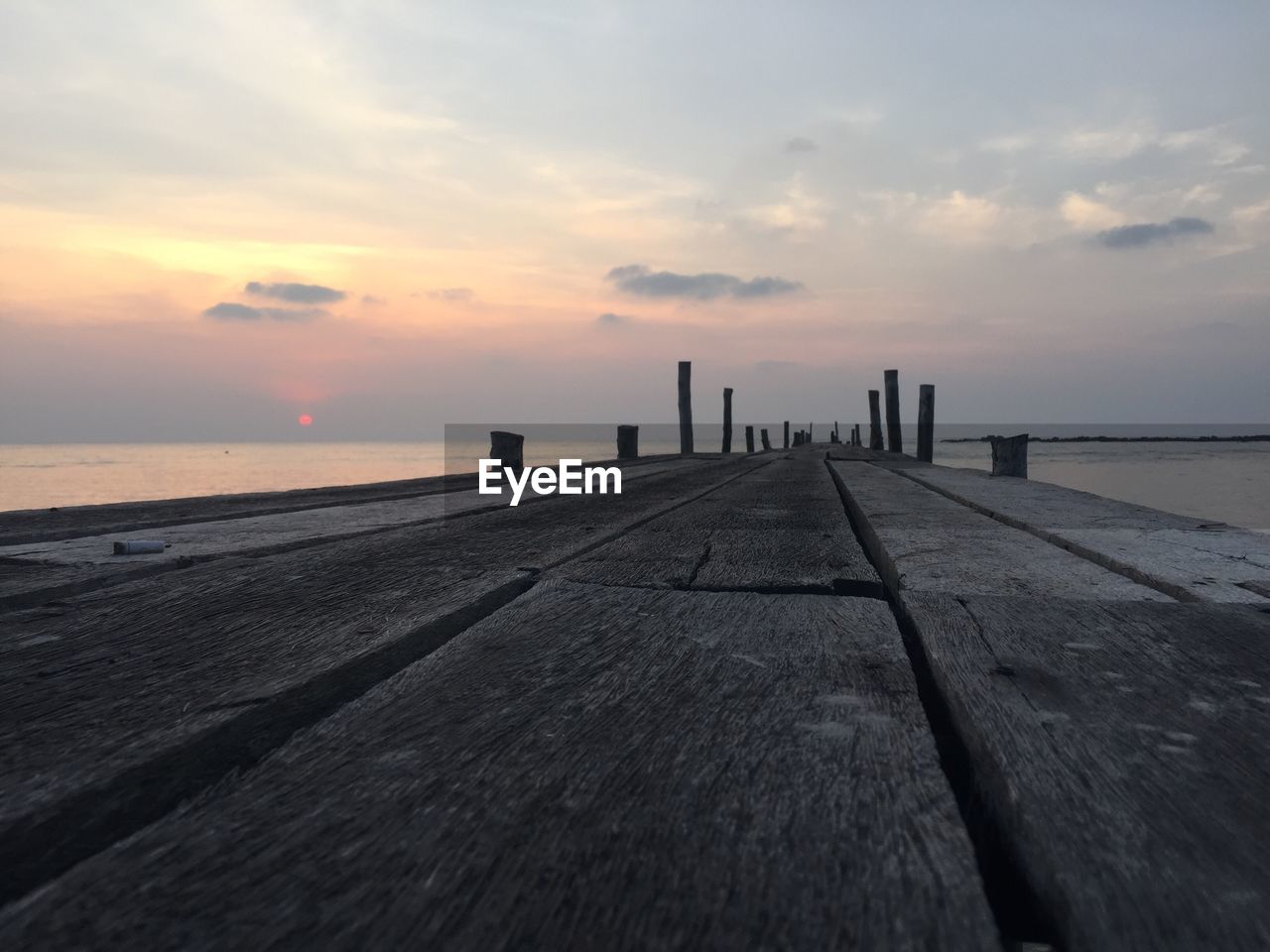 Close-up of wooden jetty at sunset