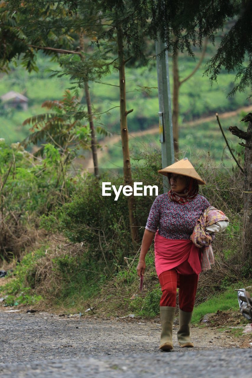 Full length of woman walking in forest