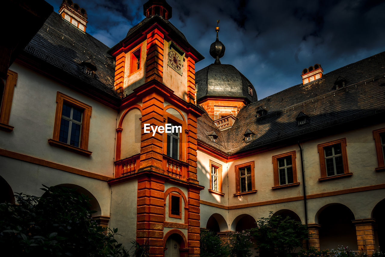 Low angle view of illuminated building against sky