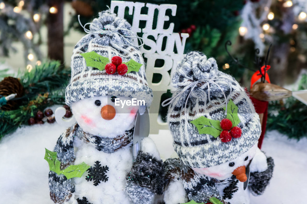 CLOSE-UP OF CHRISTMAS DECORATIONS ON SNOW DURING WINTER