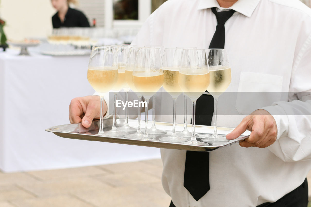 A waiter serving champagne at a wedding