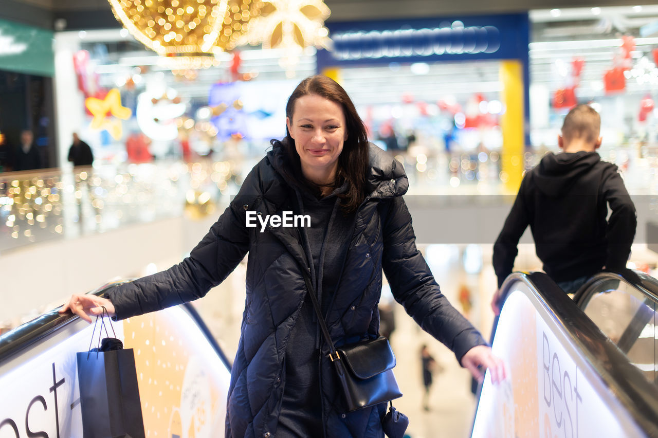 Woman on shopping mall escalator