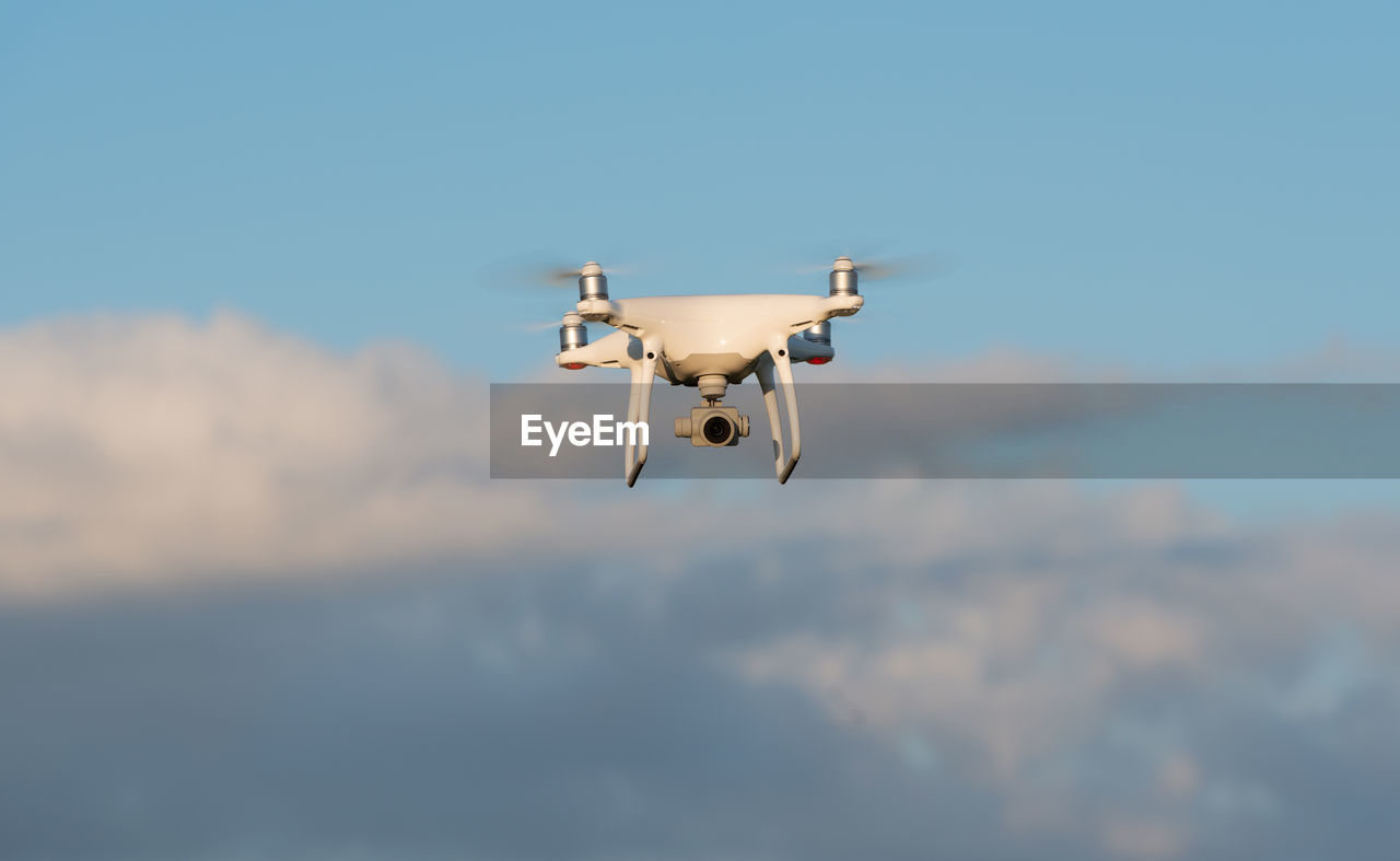 LOW ANGLE VIEW OF AIRPLANE FLYING IN SKY