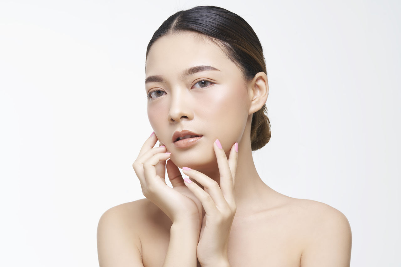 Portrait of a beautiful young woman over white background