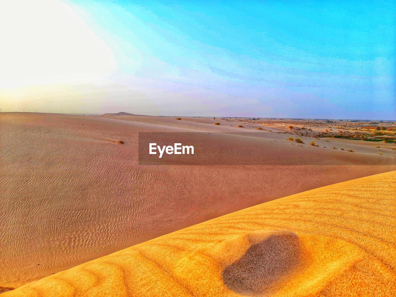 SCENIC VIEW OF SAND DUNE AGAINST SKY