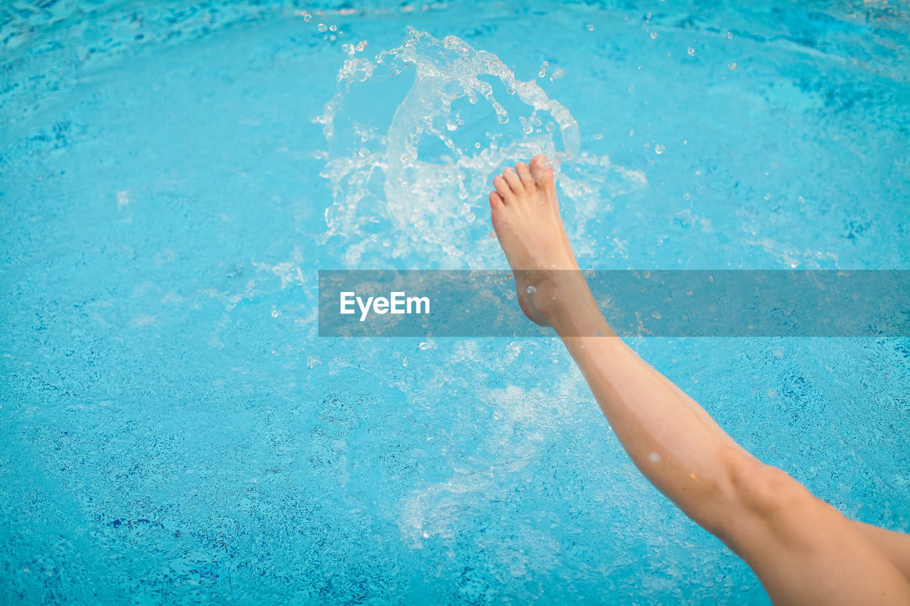 Low section of woman in swimming pool