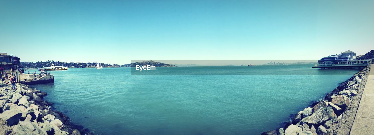 PANORAMIC SHOT OF BAY AGAINST CLEAR SKY