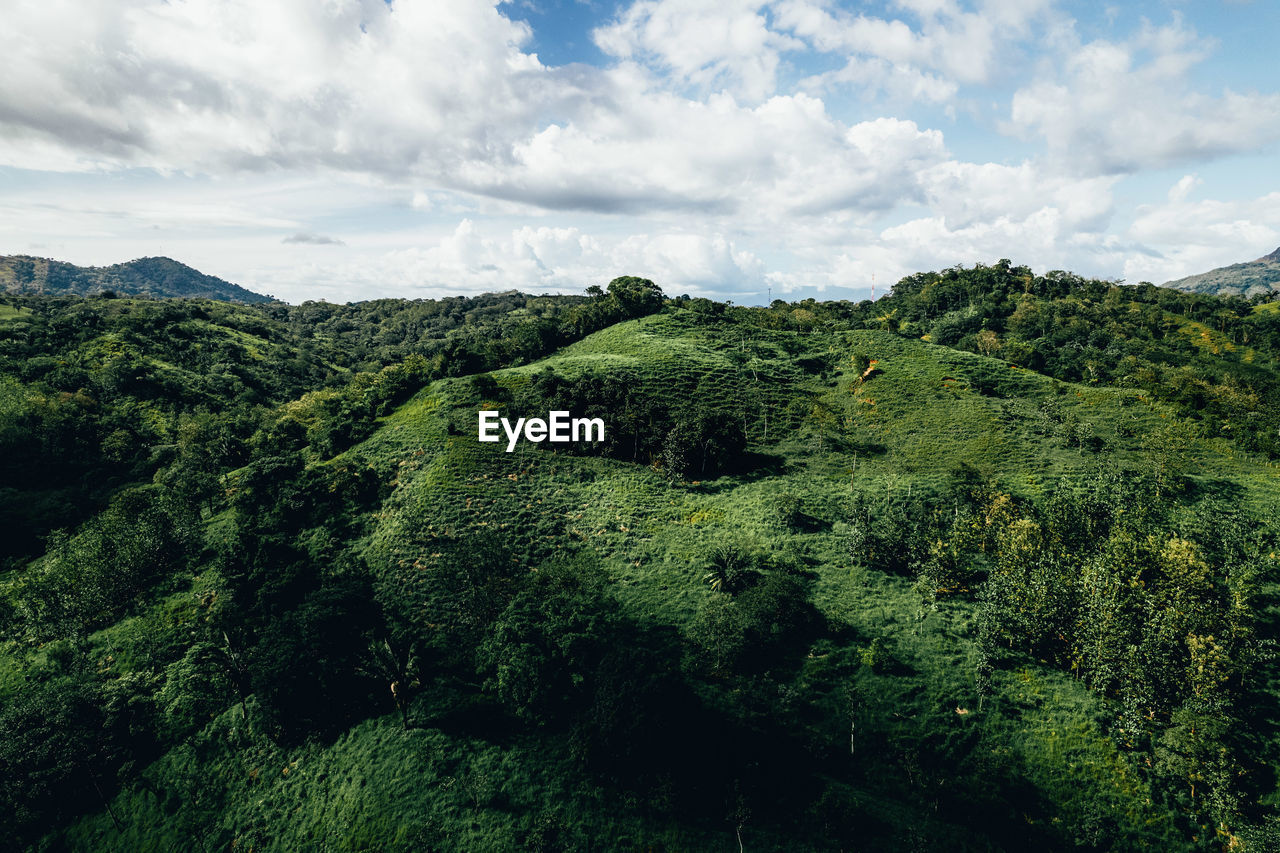 scenic view of landscape against cloudy sky