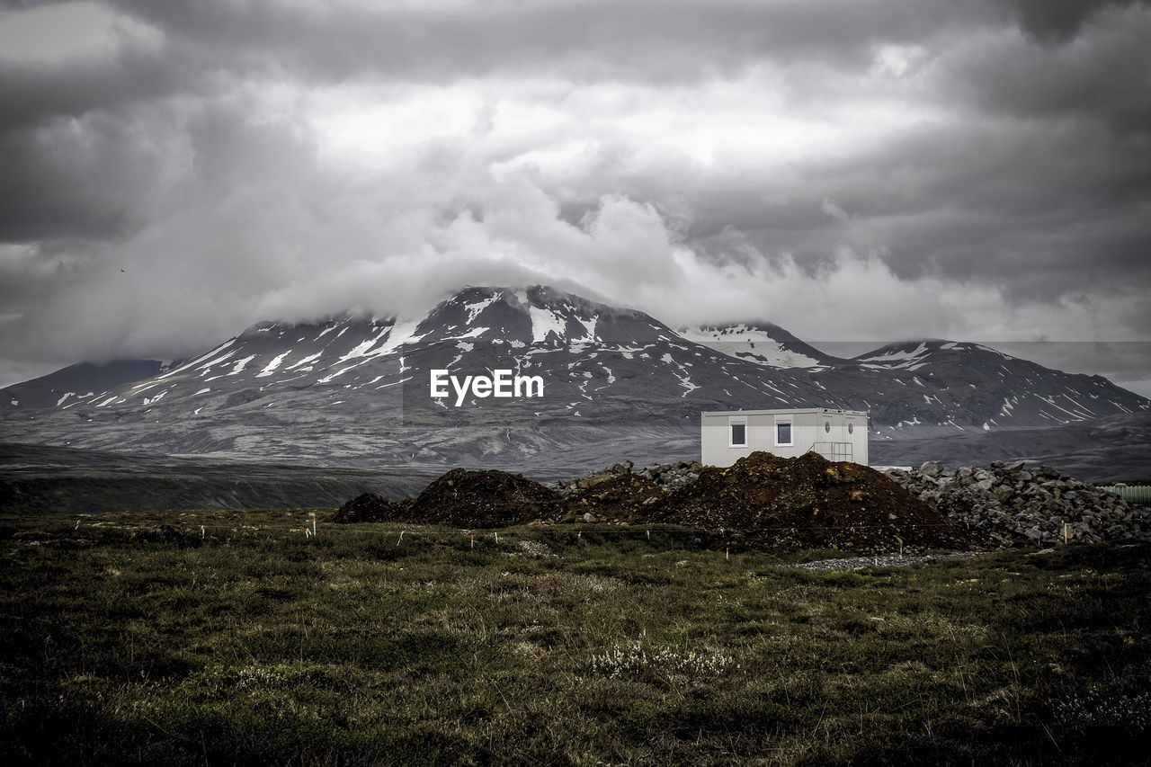 Scenic view of mountains against cloudy sky