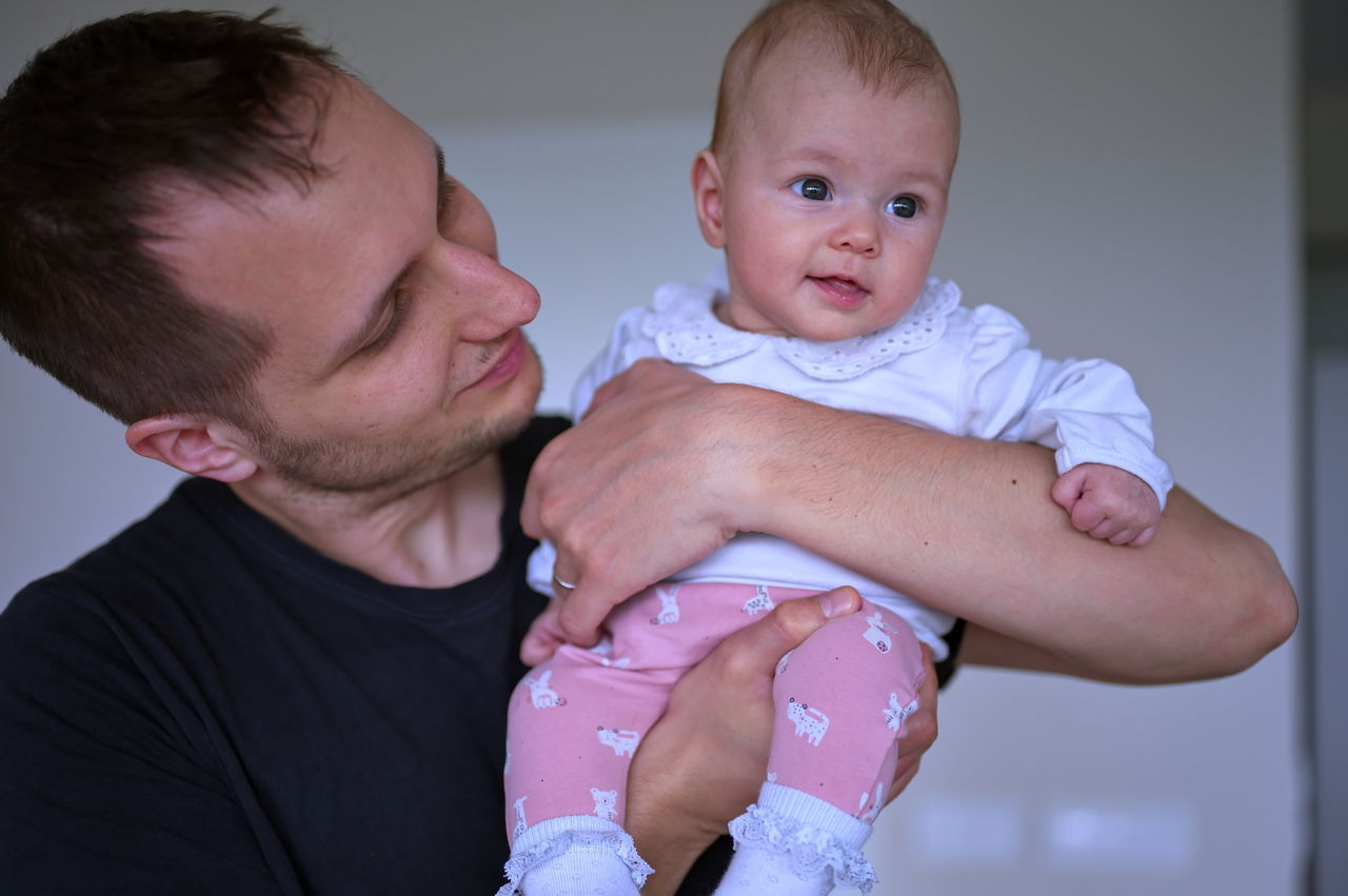 Father holding his cute little baby girl