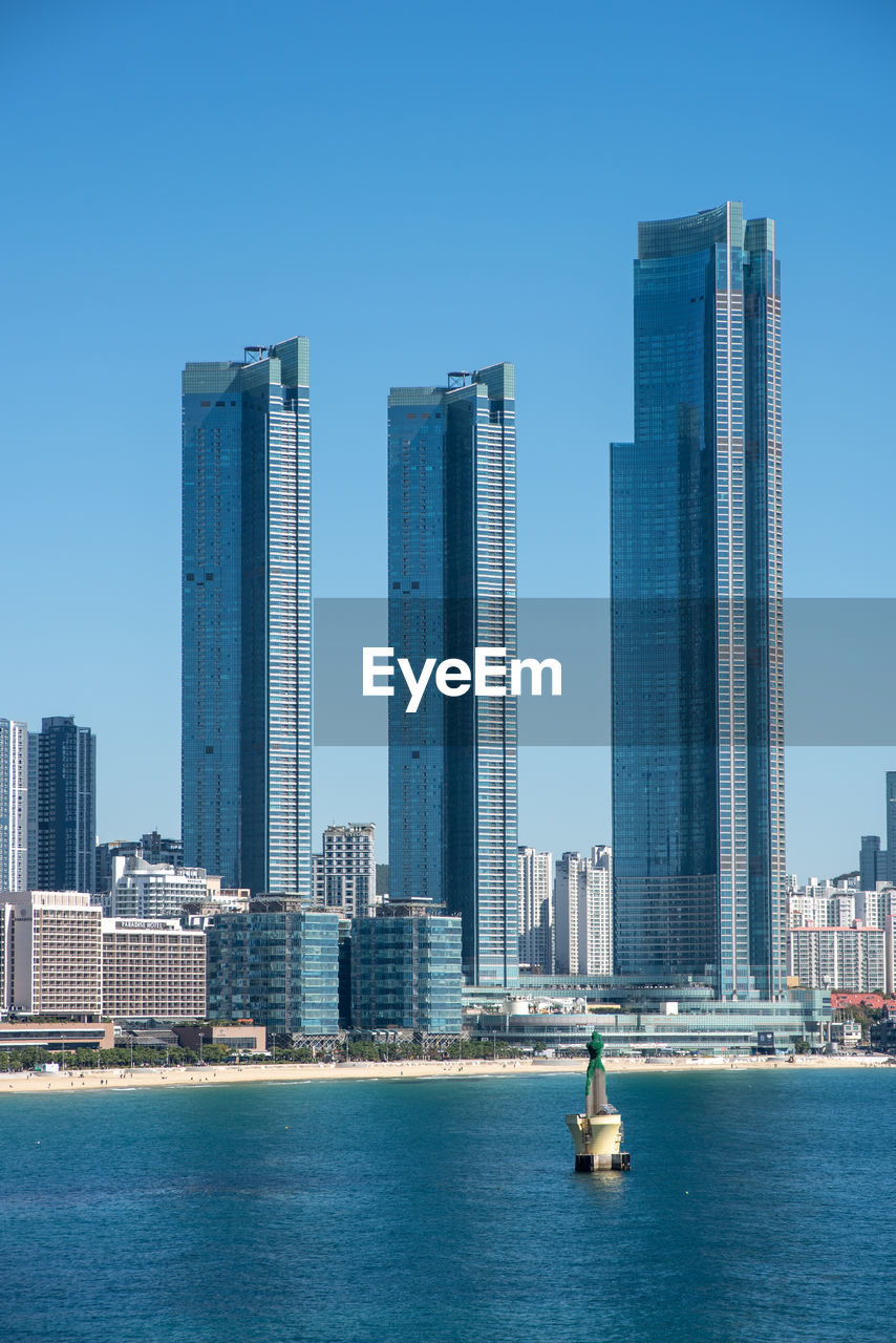 modern buildings in city against clear blue sky