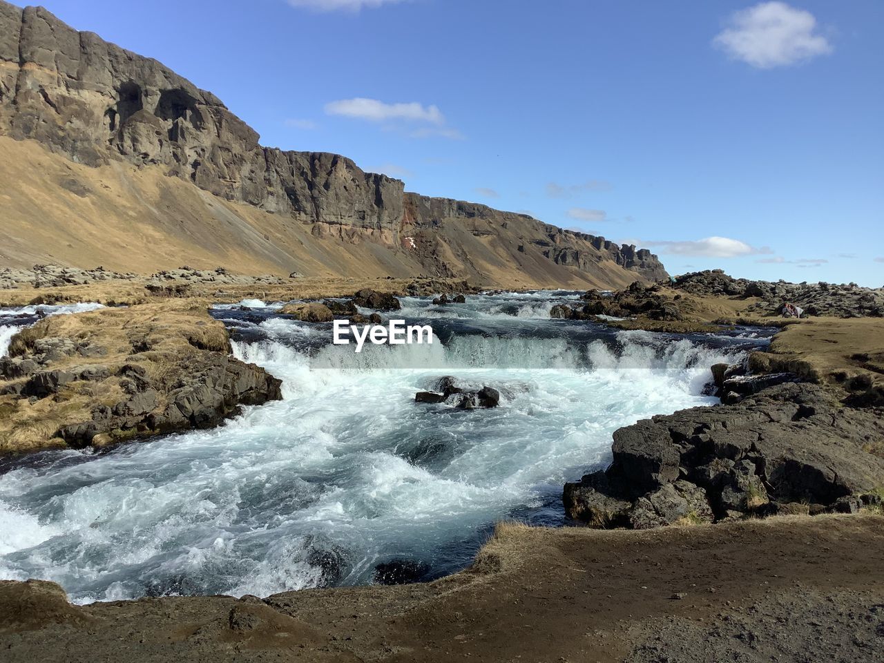 Scenic view of rapids creek against sky