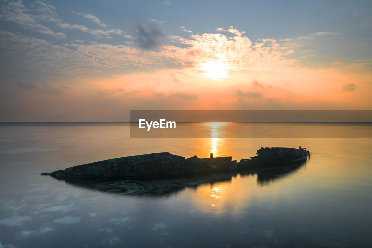 SCENIC VIEW OF SUNSET OVER SEA