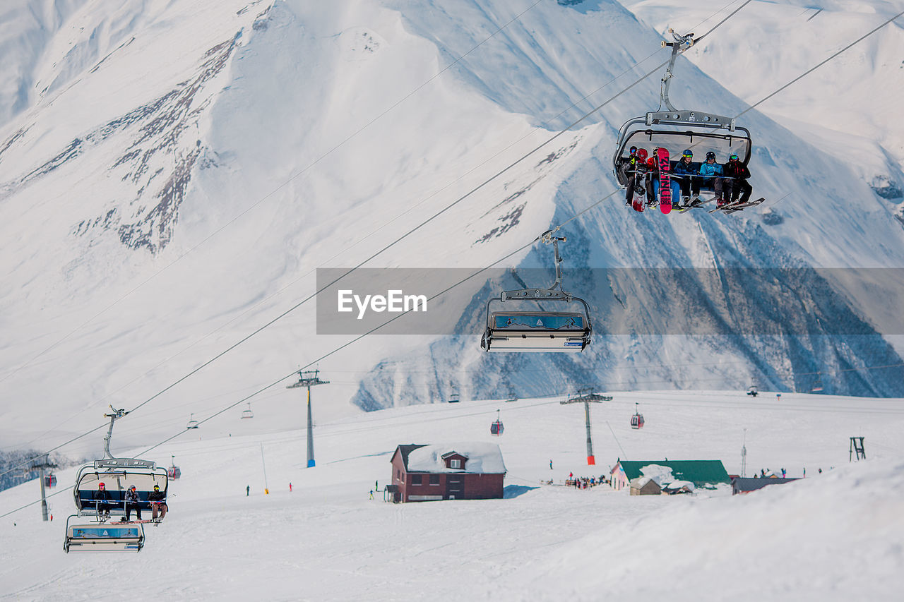 SKI LIFT AMIDST SNOWCAPPED MOUNTAINS