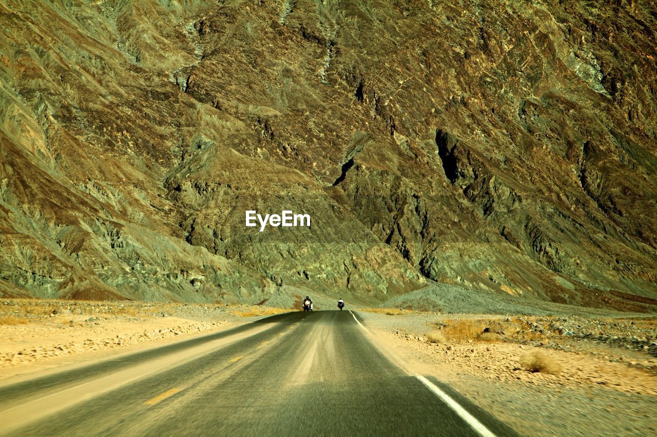 AERIAL VIEW OF ROAD PASSING THROUGH MOUNTAIN