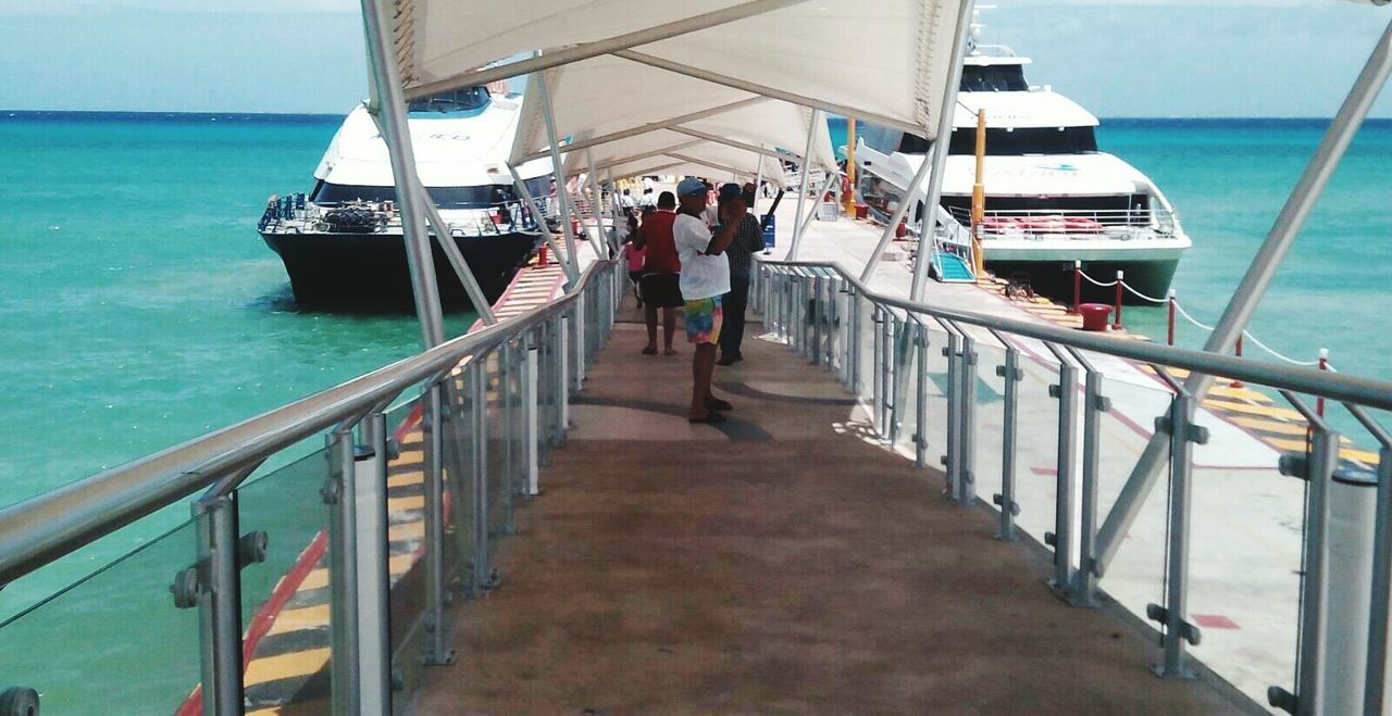 PEOPLE WALKING ON BOAT SAILING ON SEA