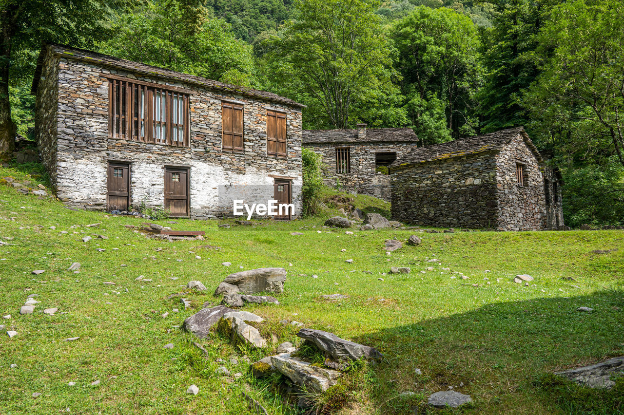 Ruined stone houses and mills in an abandoned mountain village in the alps