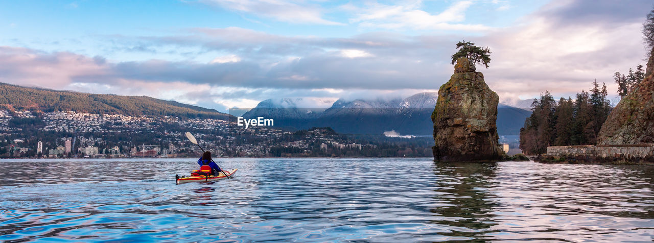 rear view of man skiing in sea against sky