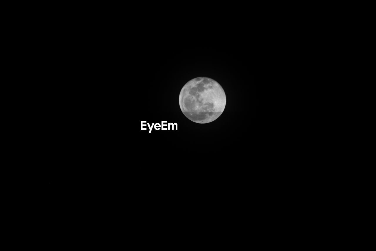 Low angle view of moon against clear sky at night