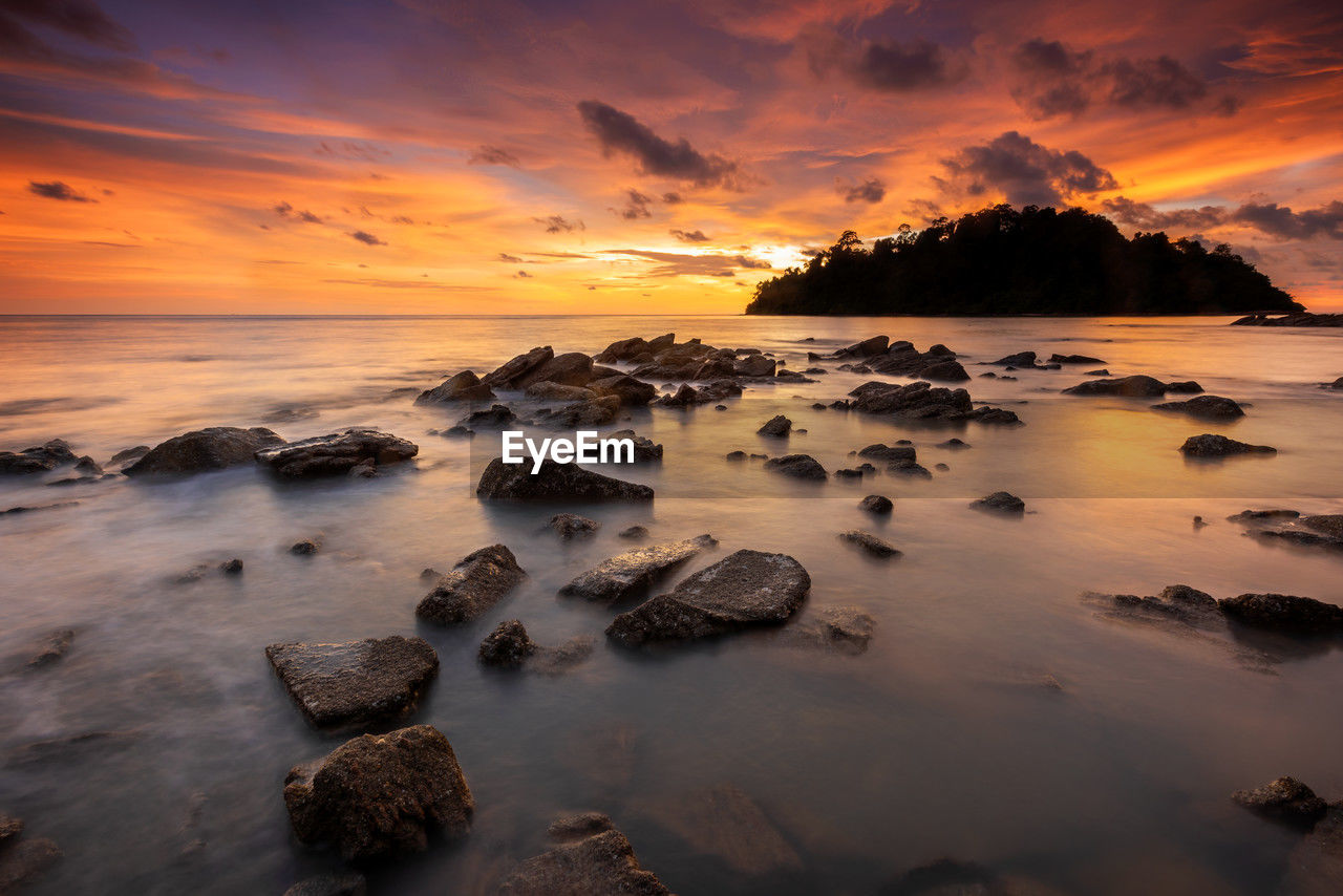 Tranquil sunset over rocky coastal landscape at pulau sayak kuala muda kedah malaysia