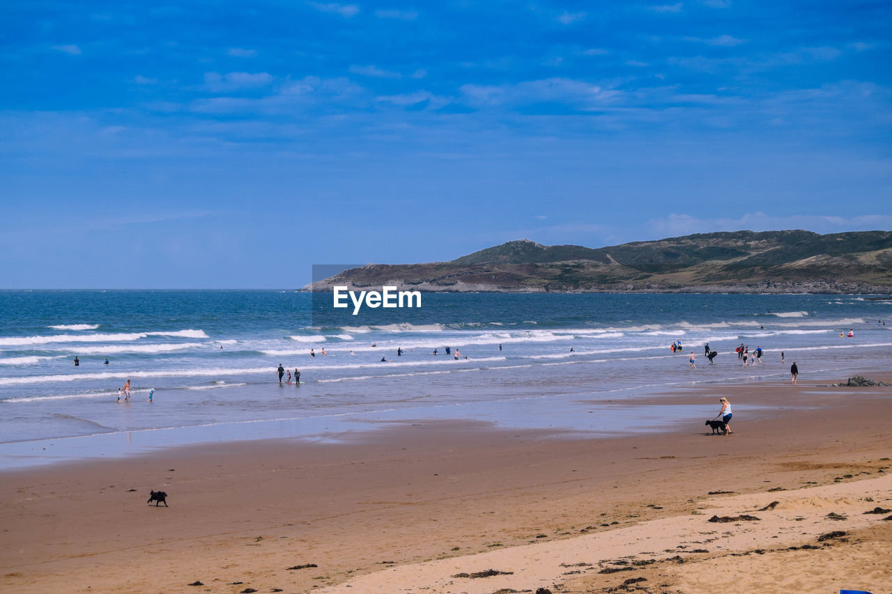 Scenic view of beach against blue sky