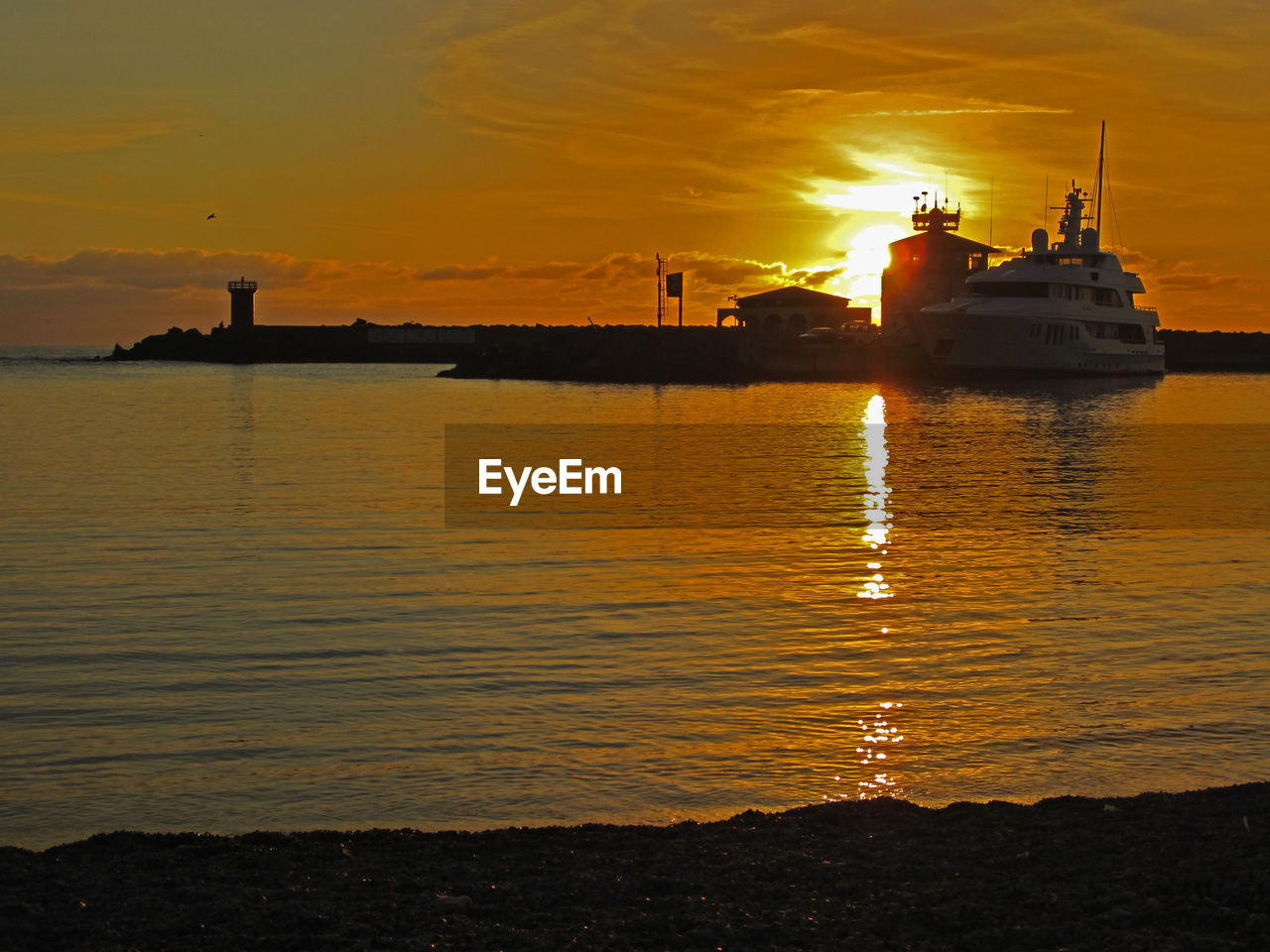 VIEW OF SEA AGAINST ORANGE SKY