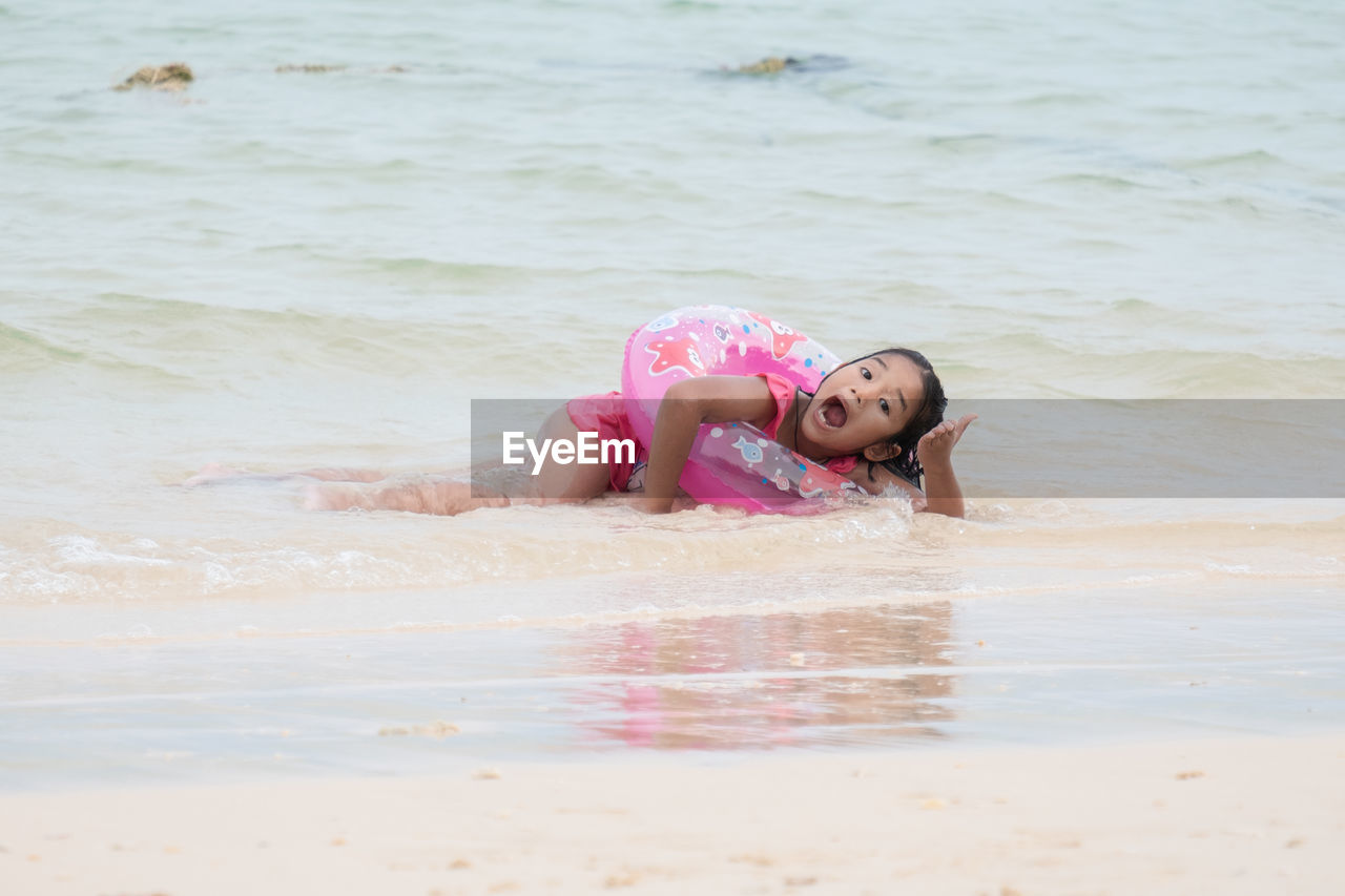 PORTRAIT OF GIRL IN PINK SEA