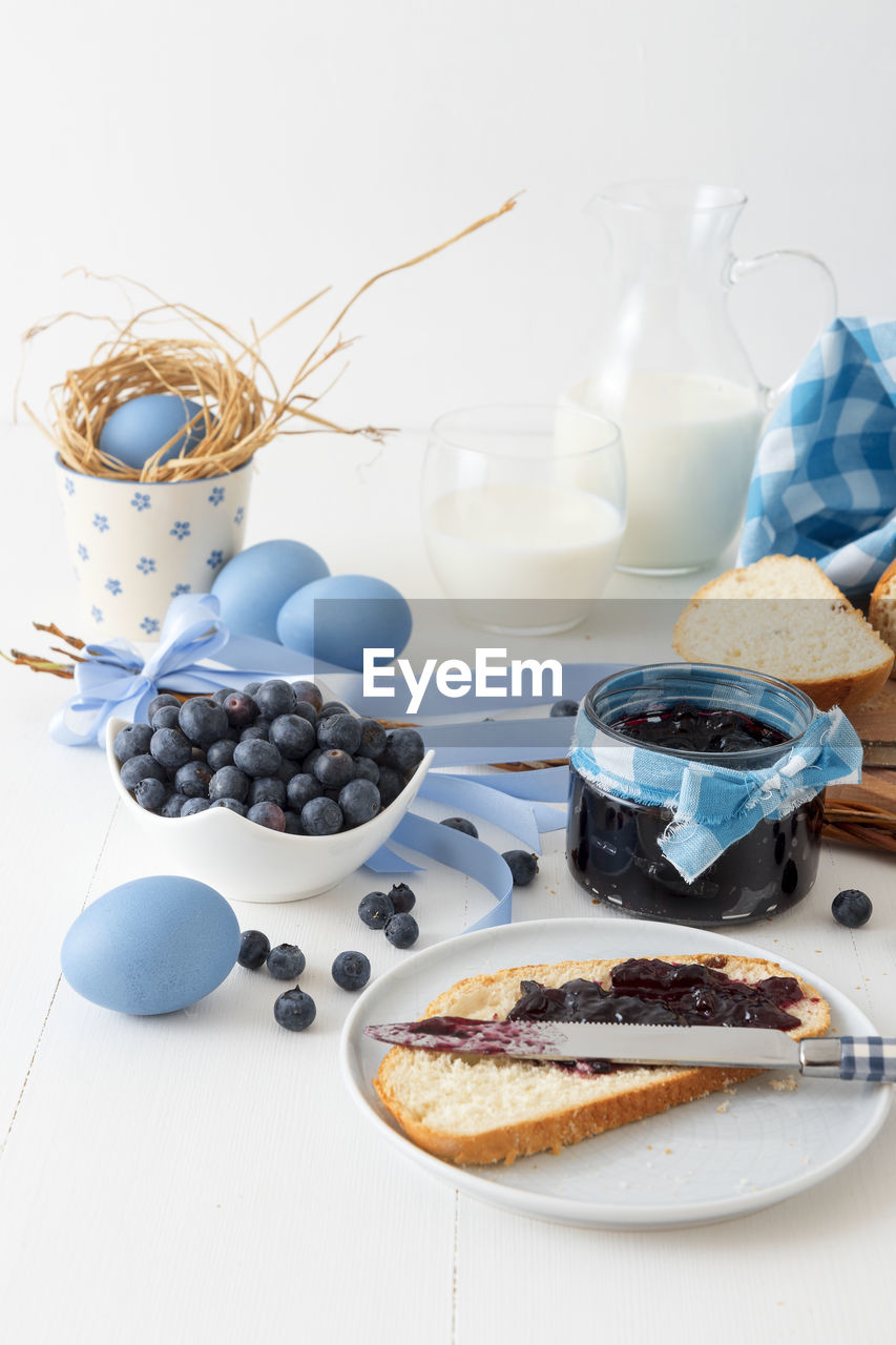 Traditional czech easter food and symbols, pastry mazanec, eggs and pomlazka. 