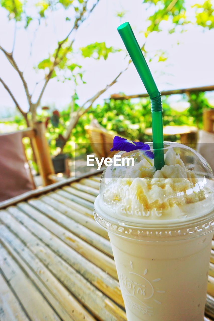food and drink, fast food, food, refreshment, sweet food, dairy, drink, frozen, dessert, soft drink, freshness, ice cream, sweet, drinking straw, straw, produce, breakfast, summer, no people, frozen food, focus on foreground, fruit, nature, meal, cold temperature, milkshake, plant, healthy eating, day, outdoors, disposable, household equipment, dish, drinking glass, table, cup, glass, close-up