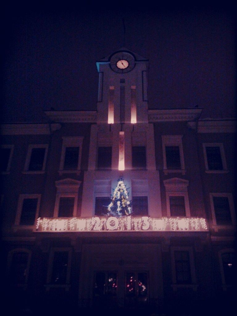 LOW ANGLE VIEW OF ILLUMINATED BUILT STRUCTURE