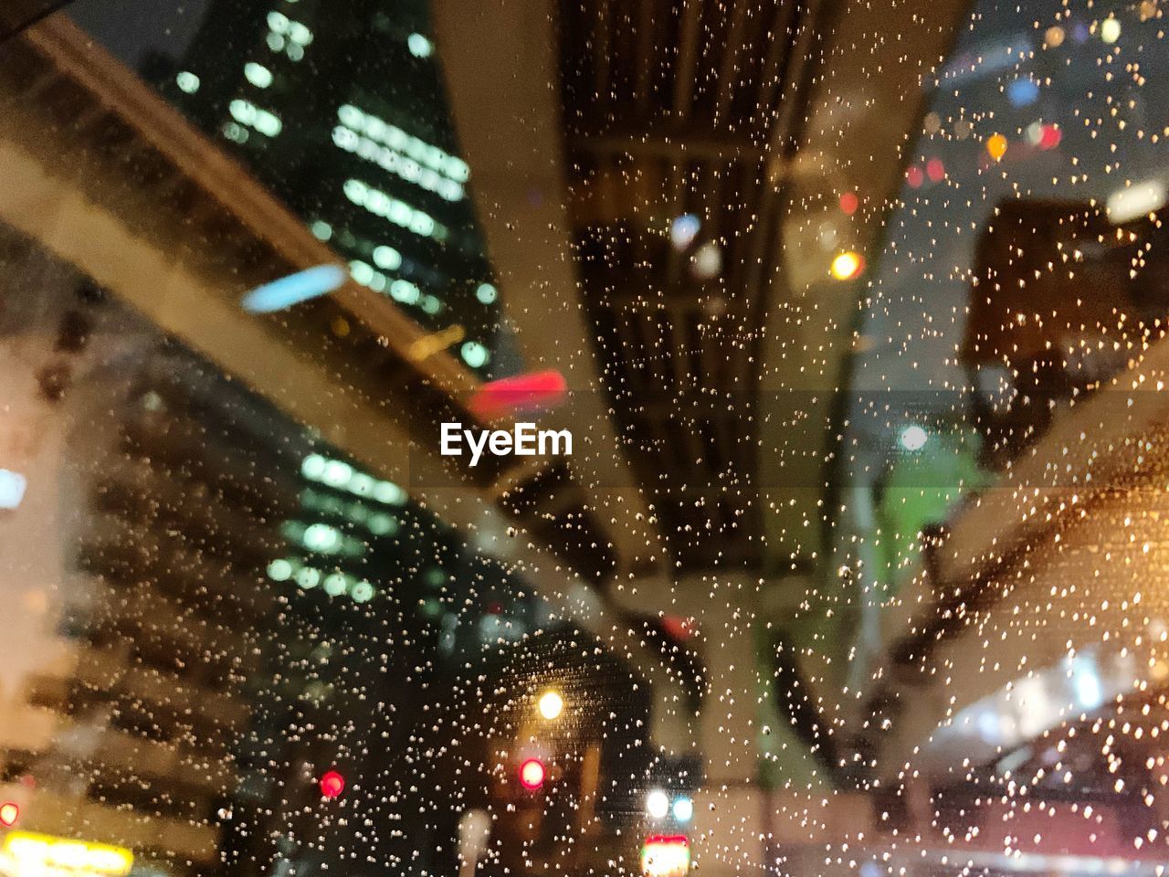 Buildings seen through wet glass window at night