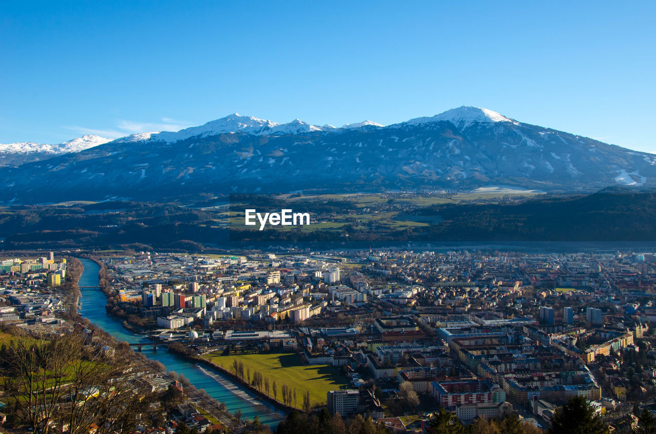 high angle view of townscape and mountains against clear sky