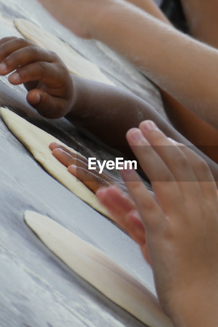 Cropped hands of children preparing food