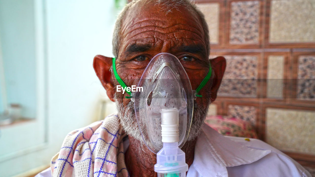 PORTRAIT OF A MAN DRINKING WATER FROM PIPE