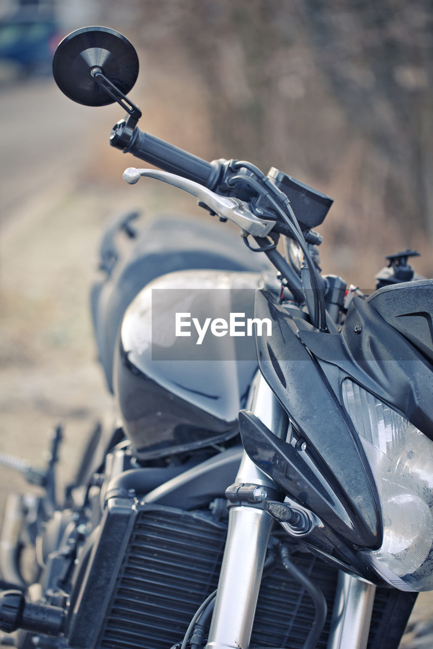 transportation, motorcycle, mode of transportation, vehicle, land vehicle, focus on foreground, road, bicycle, cruiser, day, city, outdoors, headwear, handlebar, riding, sports helmet, street, motorcycling, auto part, travel, blue, headlight