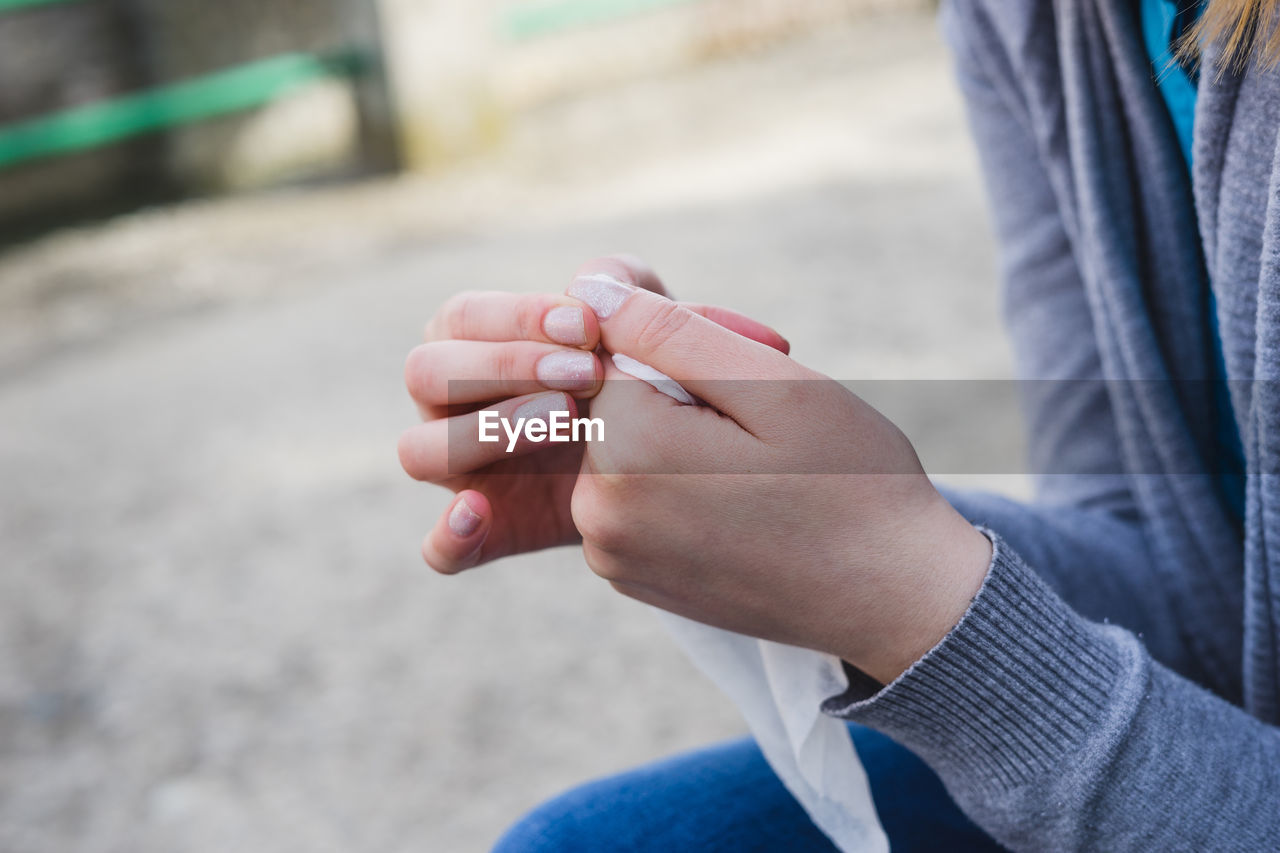 Midsection of woman holding tissue paper