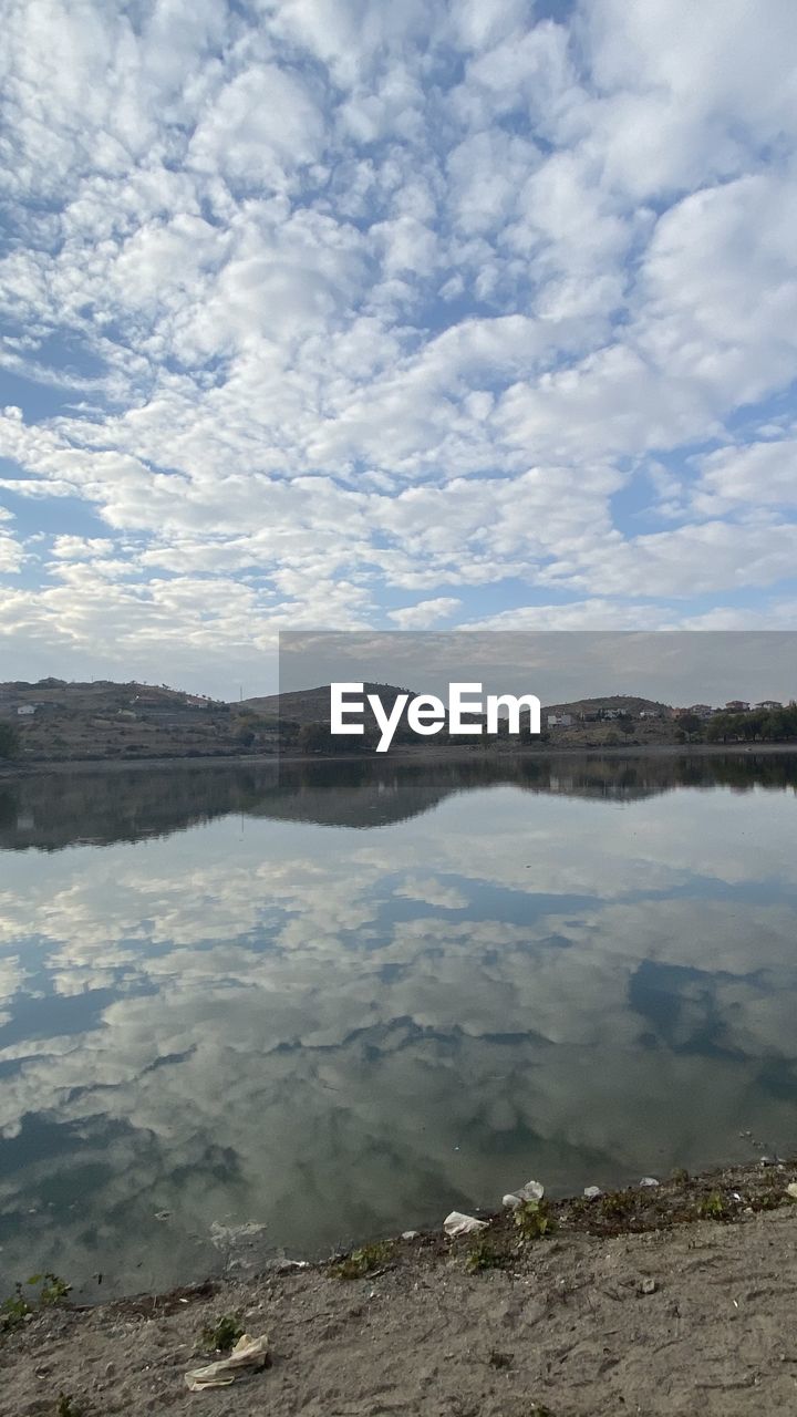 SCENIC VIEW OF CALM LAKE AGAINST SKY