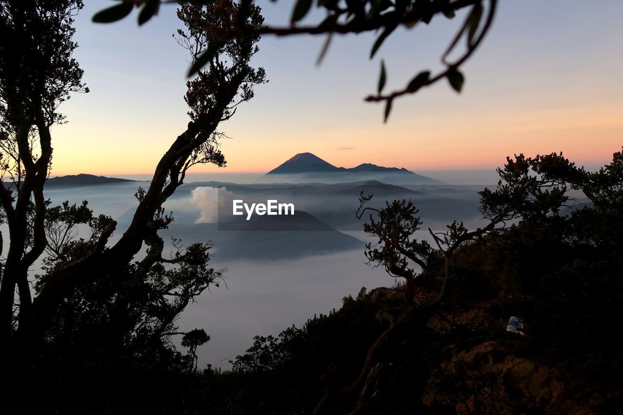 Scenic view of silhouette mountains against sky at sunset