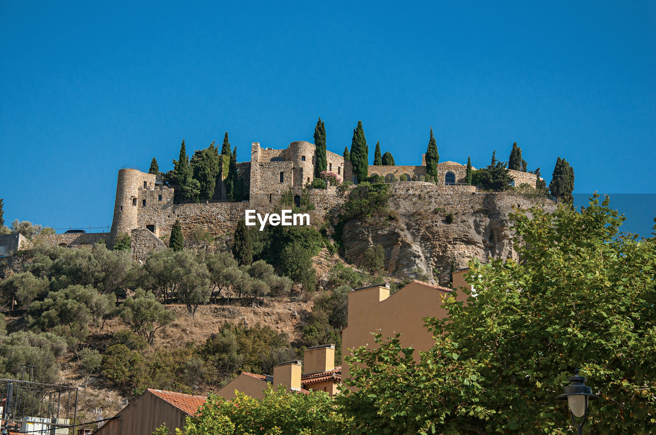 View of castle on top of a hill near the city center of cassis, france.
