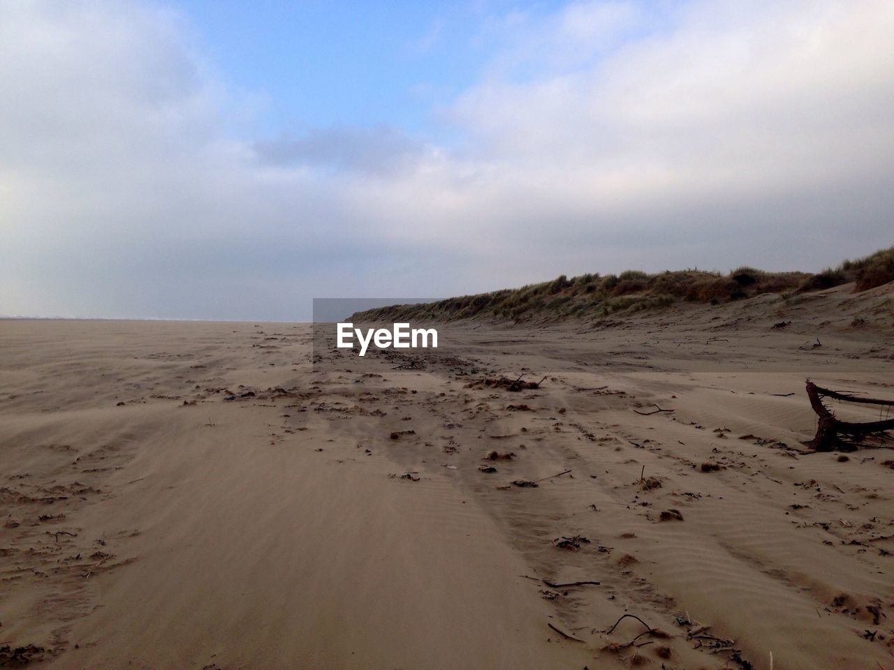 Scenic view of sand dunes against sky